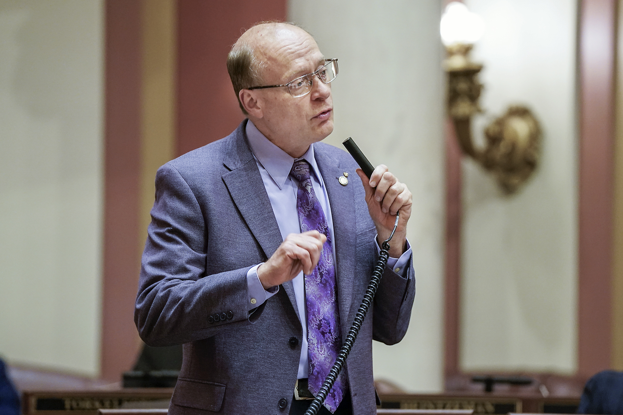 Rep. Jeff Backer introduces the omnibus health policy bill on the House Floor May 15. (Photo by Michele Jokinen)